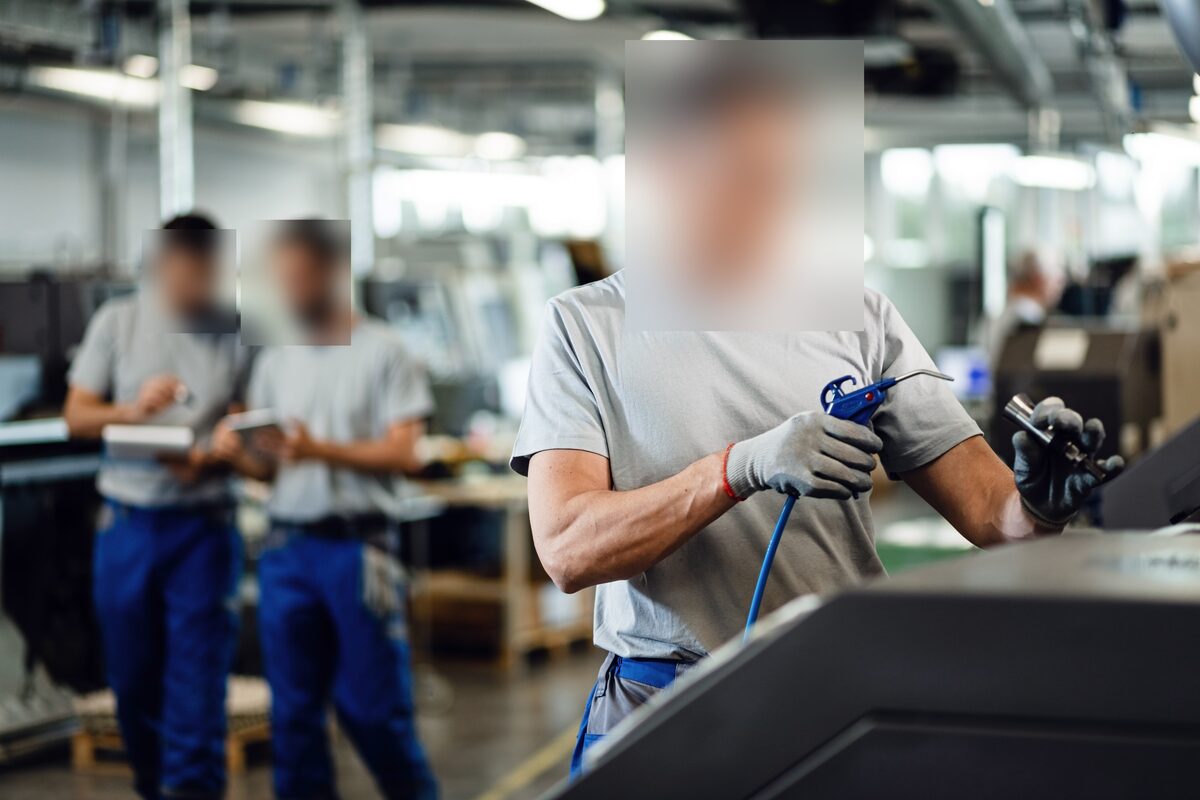 A workplace scene with faces automatically blurred for privacy